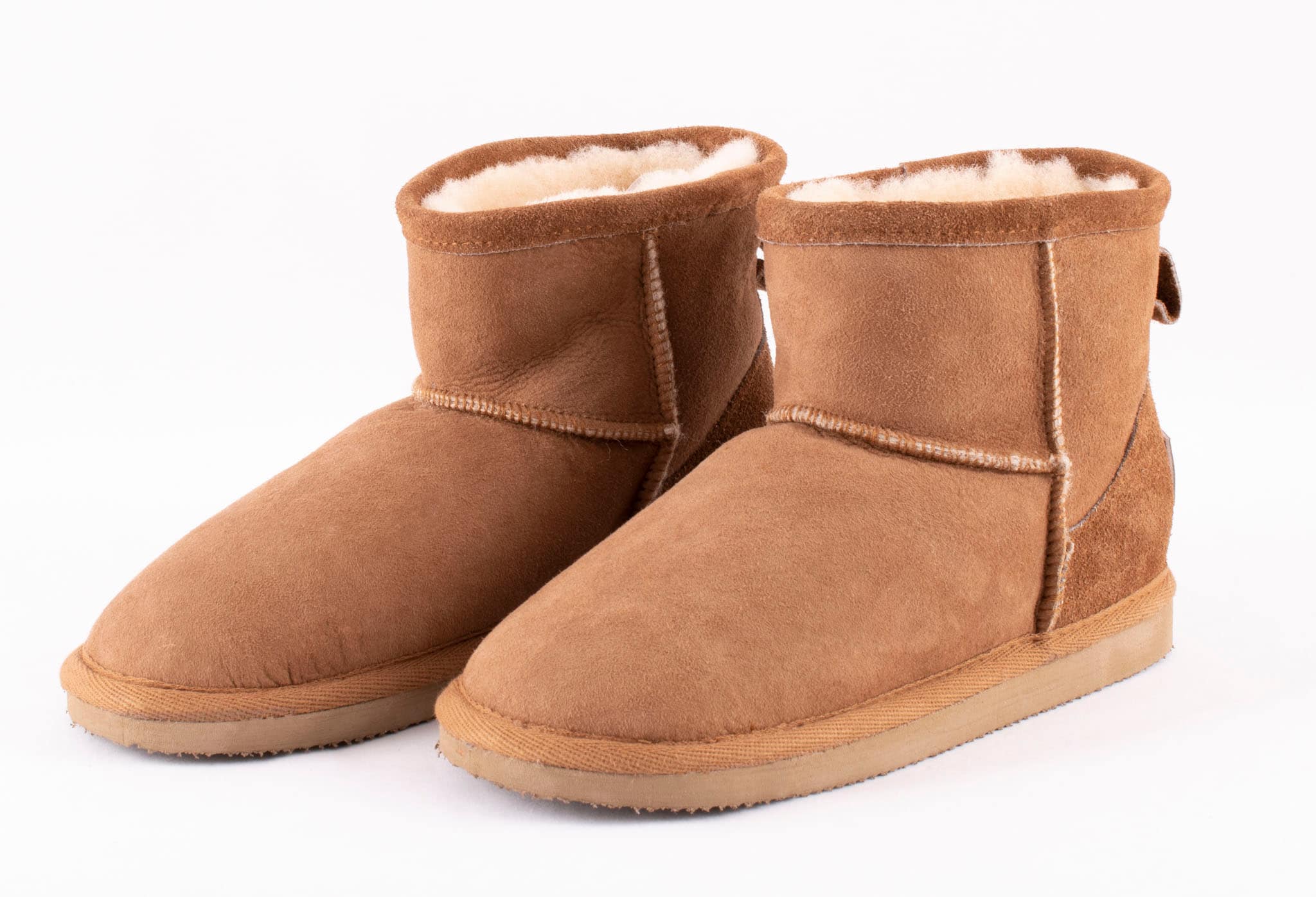 A pair of brown ankel high sheepskin boots with a warm and comfortable sheepskin inside.