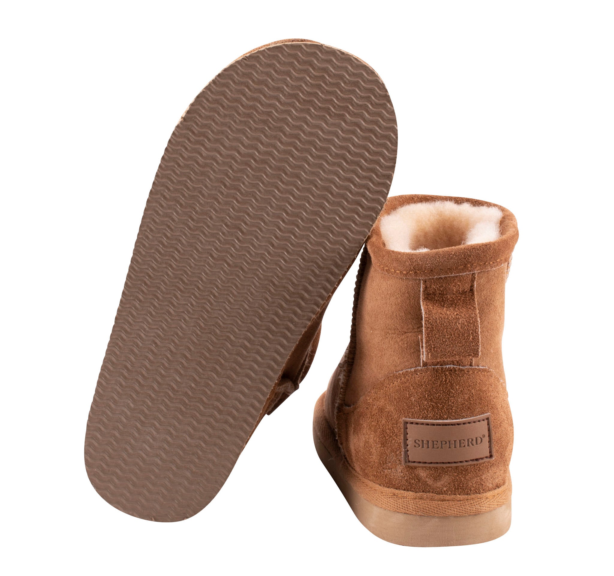 A pair of brown ankel high sheepskin boots with a warm and comfortable sheepskin inside.