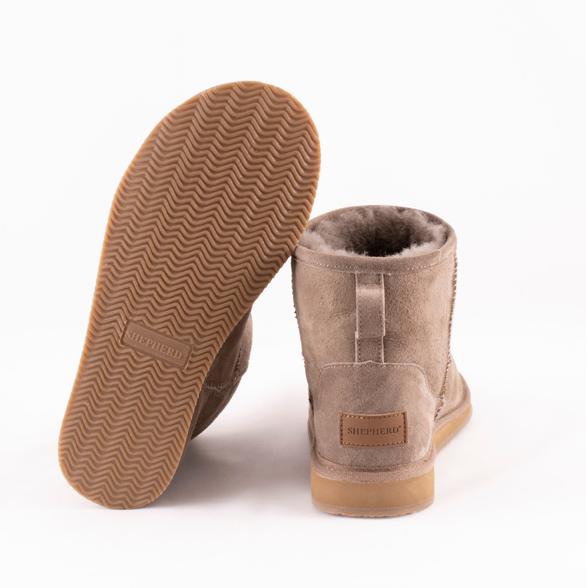 A pair of grey ankel high sheepskin boots with a warm and comfortable sheepskin inside.